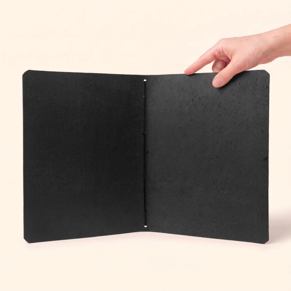 Open genuine leather notebook case revealing one elastic loop and plain insert.