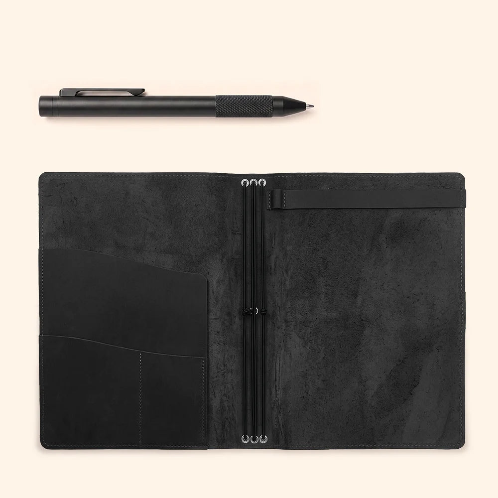 Leather journal organizer with three elastic bands, storage pockets, and sketchbook holder.