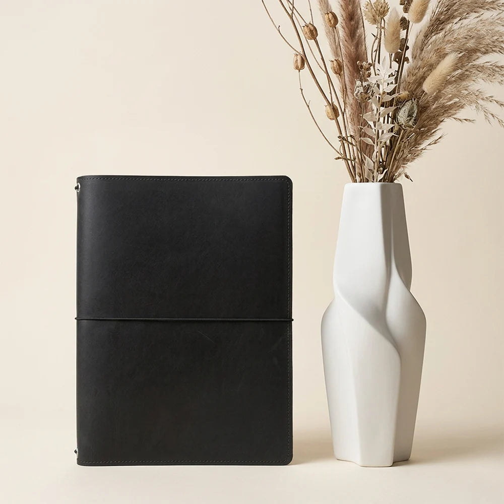 Handmade genuine leather notebook case featuring secure elastic straps and practical pockets.