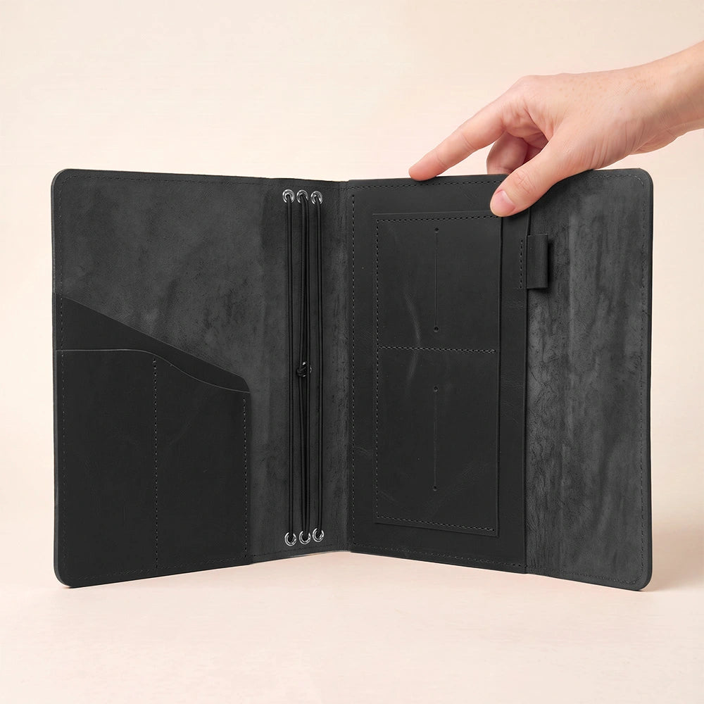 Elegant leather journal case designed with organizer compartments and stitched leather pen loop.