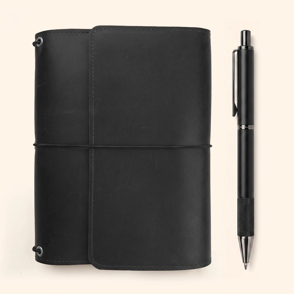 Handmade refillable leather journal cover with functional pockets and built-in pen holder.