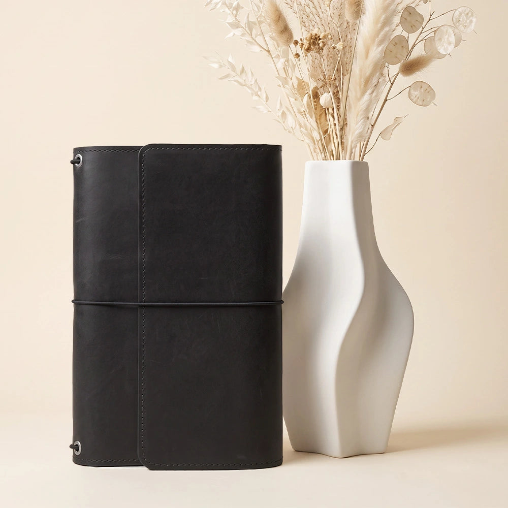 Handmade leather notebook portfolio featuring accessory pockets and leather pen retaining loop.
