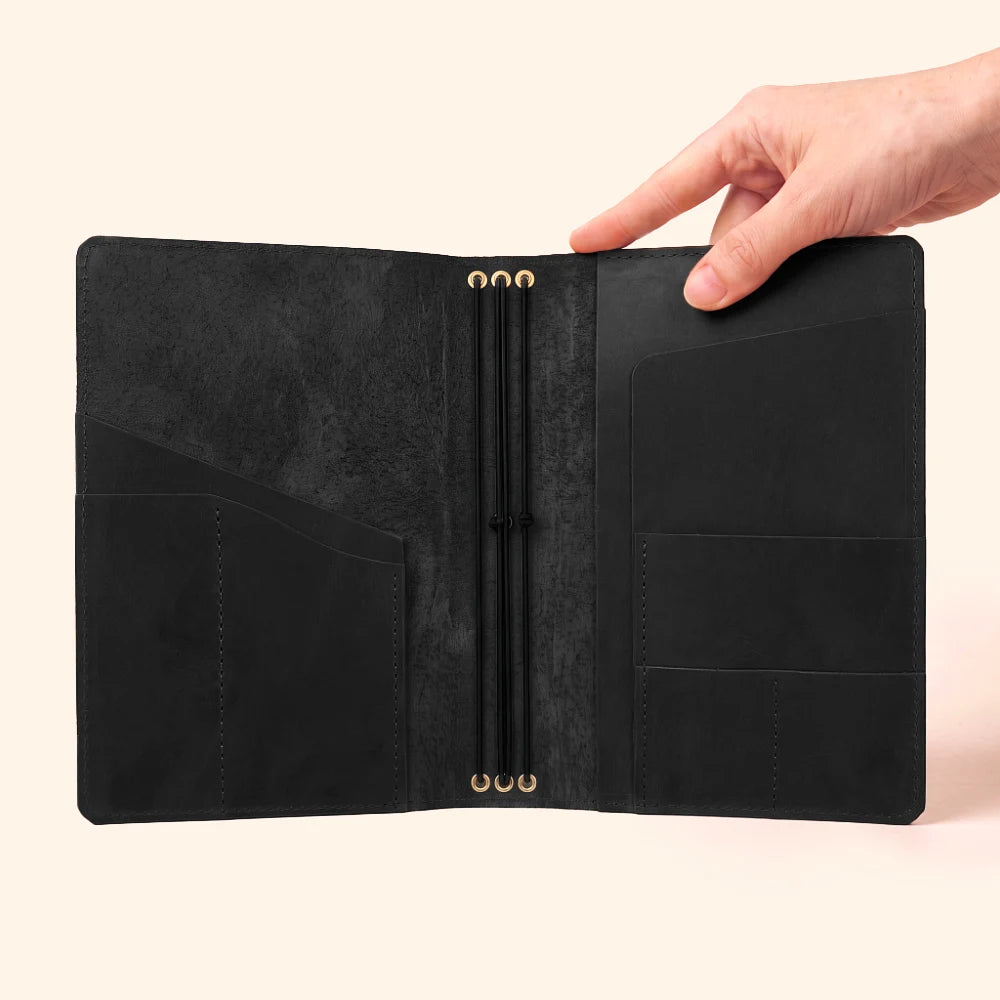 Handmade natural leather journal cover with three elastic straps for versatile organization.