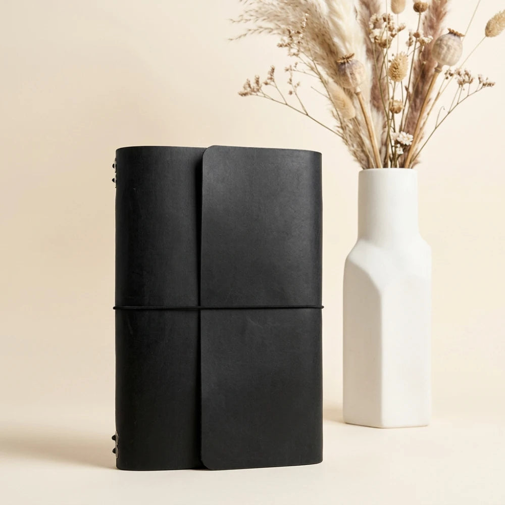 Reusable leather writing cover built to combine six separate notebook inserts.