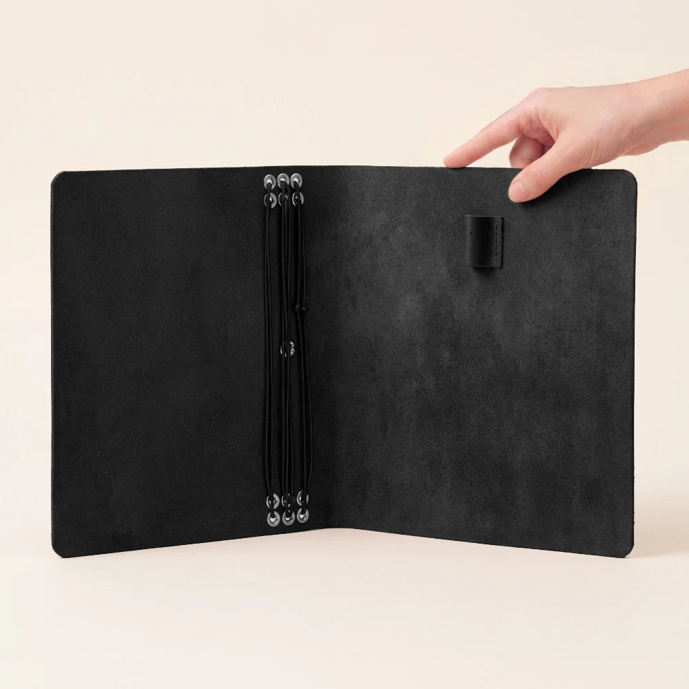 Natural leather journal case with six flexible retainers for customizable paper organization.