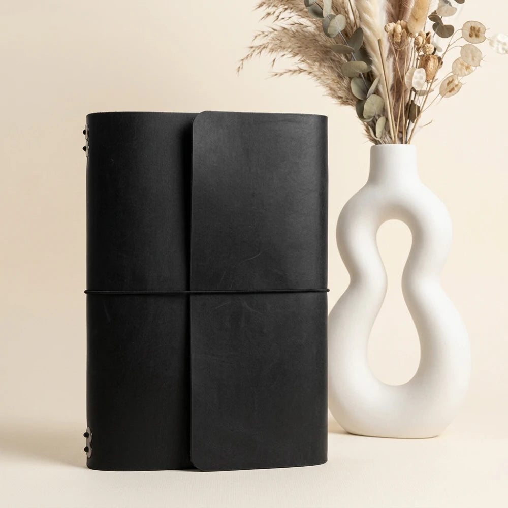 Full grain leather notebook shell with six stretch bands and accessible pen placement.