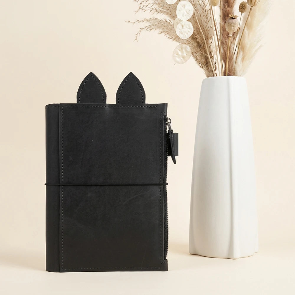 Natural leather notebook cover featuring roomy zip pocket, pen loop, leather ears, and three elastics.