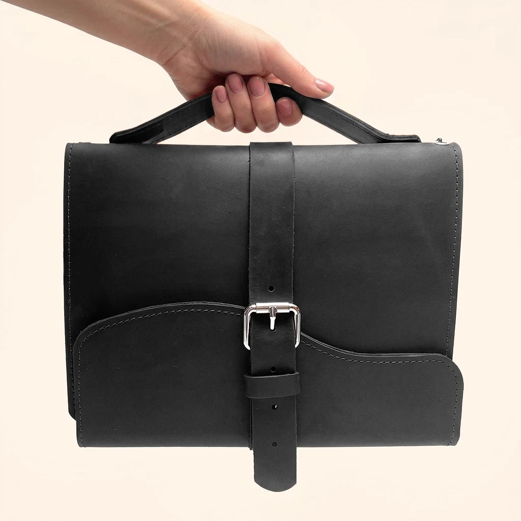 Genuine leather cover with triple elastic loops and a practical handle for portability.