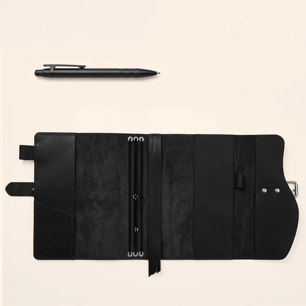 Handmade leather journal organizer with interior pockets, dedicated pen holder, bookmark, and comfortable carrying handle.