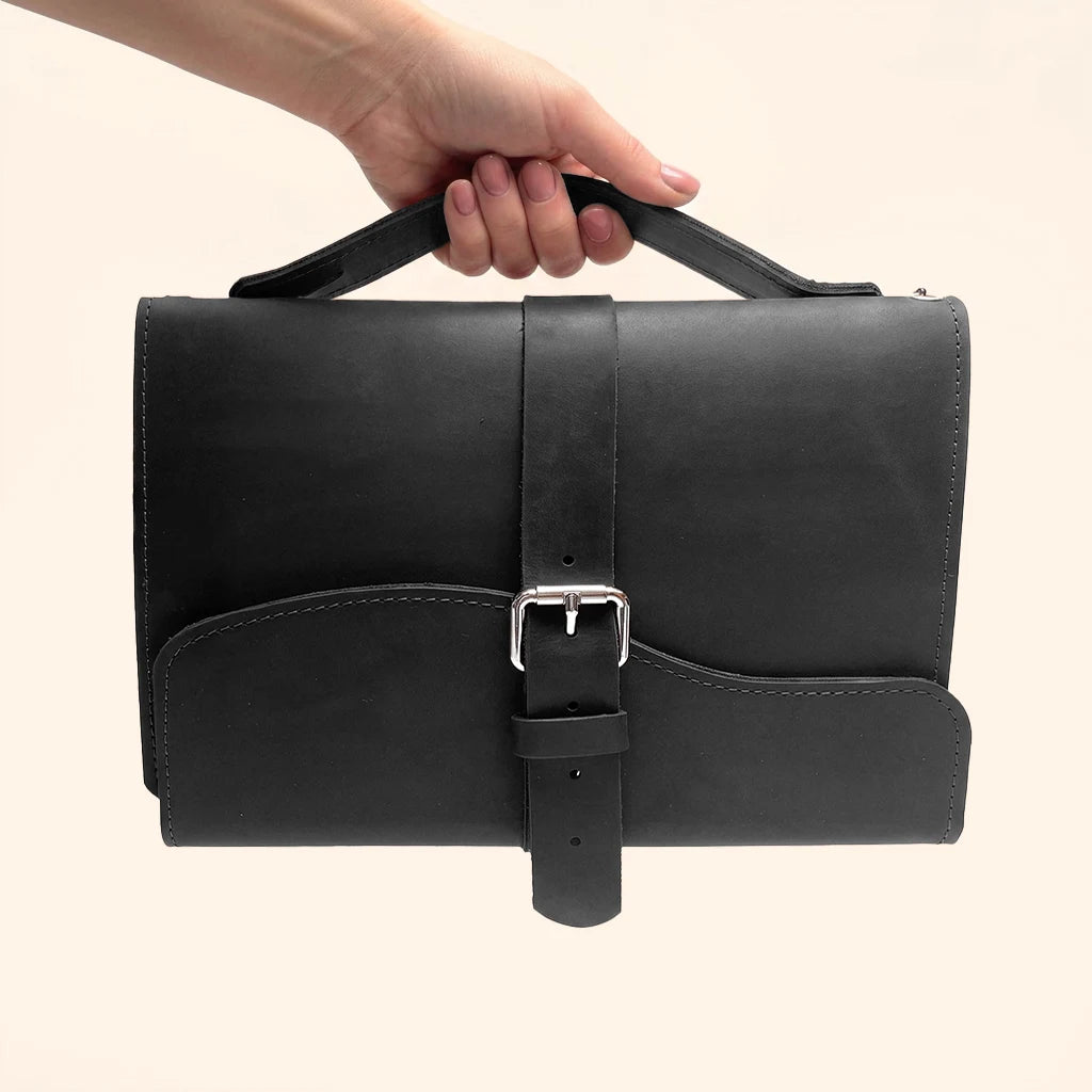 Refillable leather organizer featuring three elastic bands for securely holding notebook inserts.