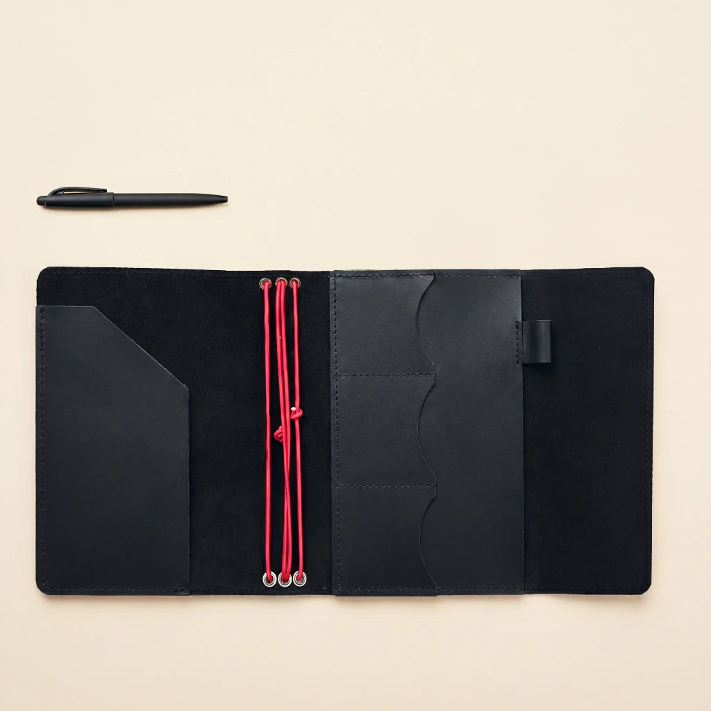 Elegant leather notebook holder with elastic straps and convenient writing tool loop