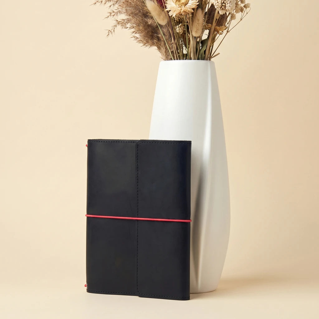 Handmade leather notebook holder with elastic closure and natural rustic texture