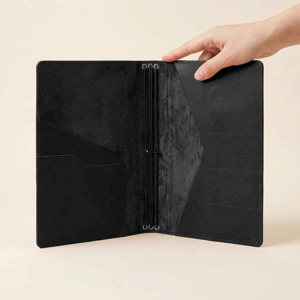 Genuine leather notebook folio featuring notebook elastics and organized interior compartments.