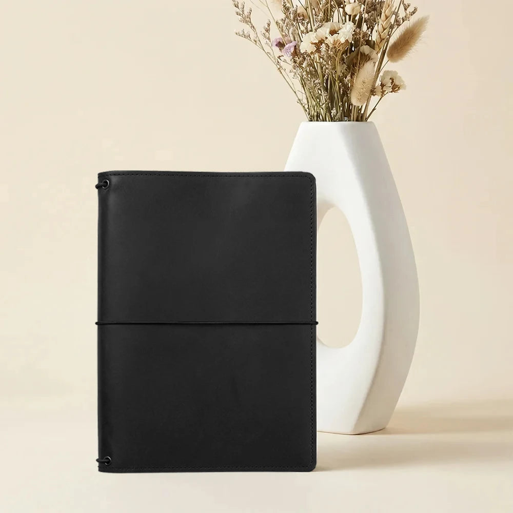 Leather notebook cover designed for everyday writing with organized interior compartments.
