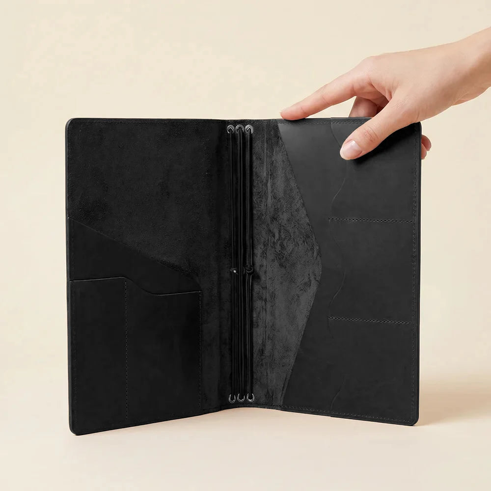 Handmade leather journal holder with elastic notebook straps and card storage pockets.