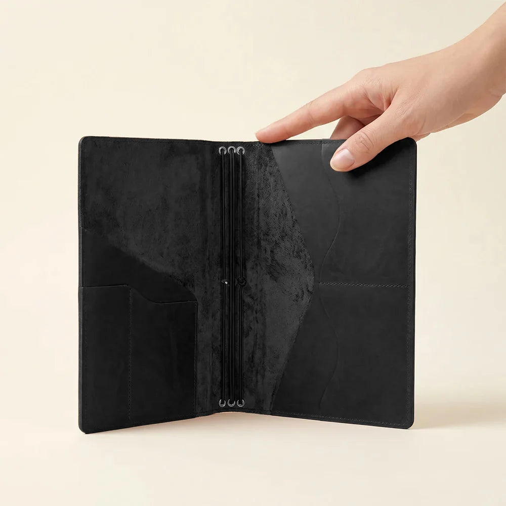 Leather notebook organizer featuring refillable notebook system and spacious interior storage pockets.