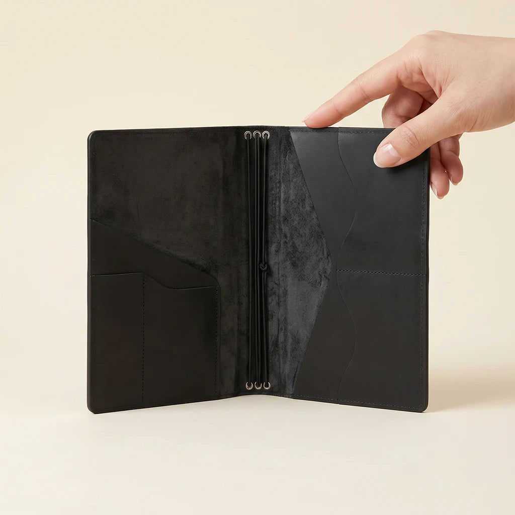 Compact leather journal cover with organized pockets and elastic bands.