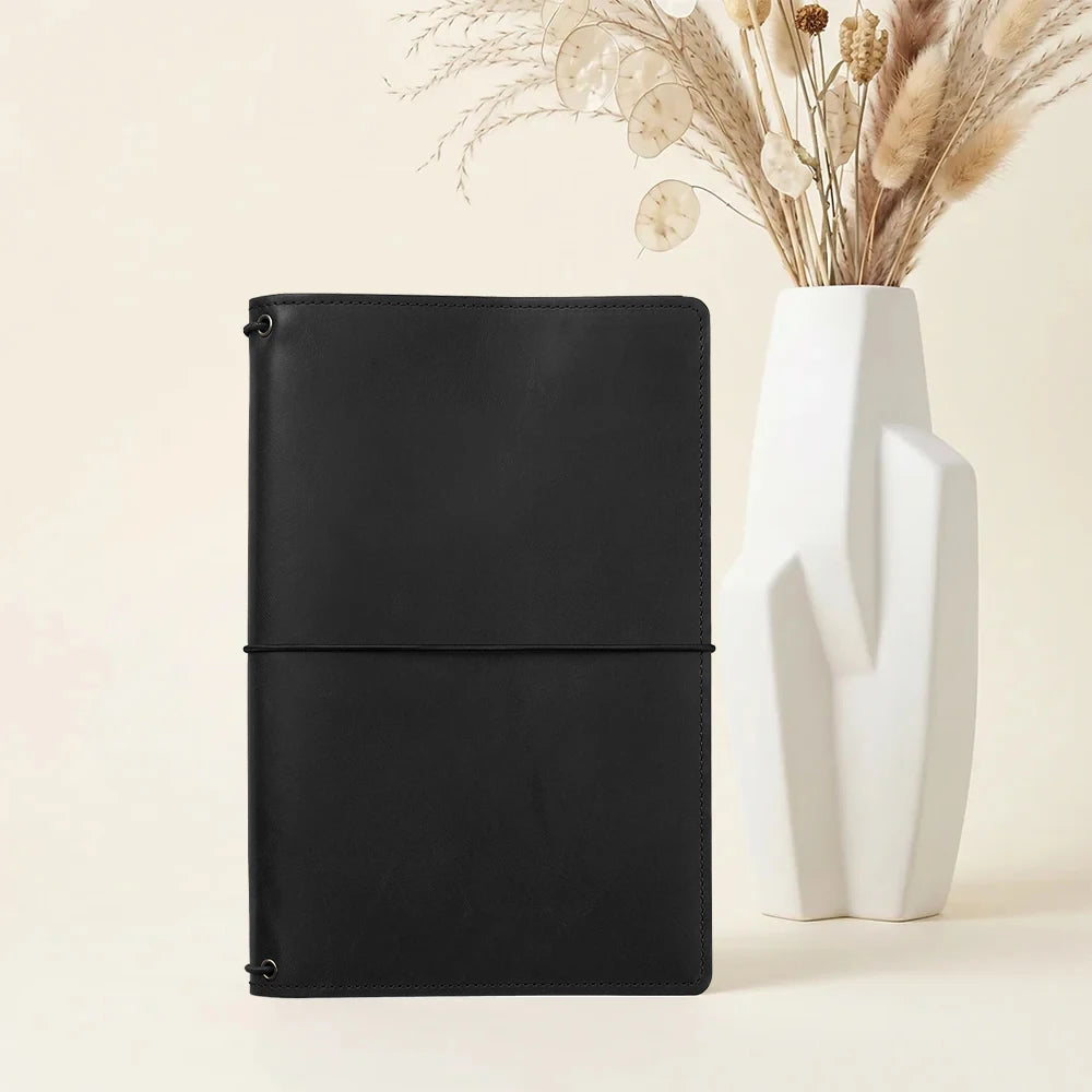 Handcrafted leather journal folio with three notebook elastics and interior organizers.