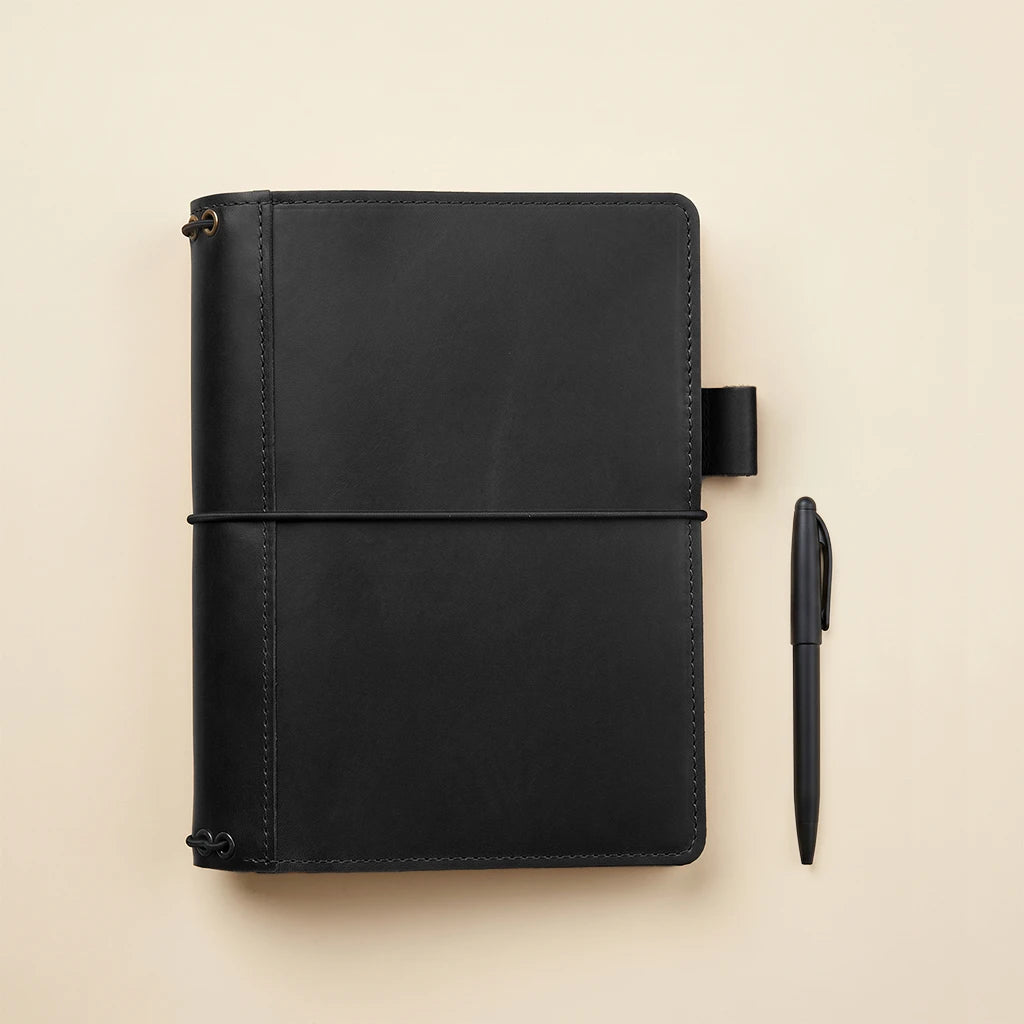 Handmade leather notebook cover with secure elastic structure and storage pockets