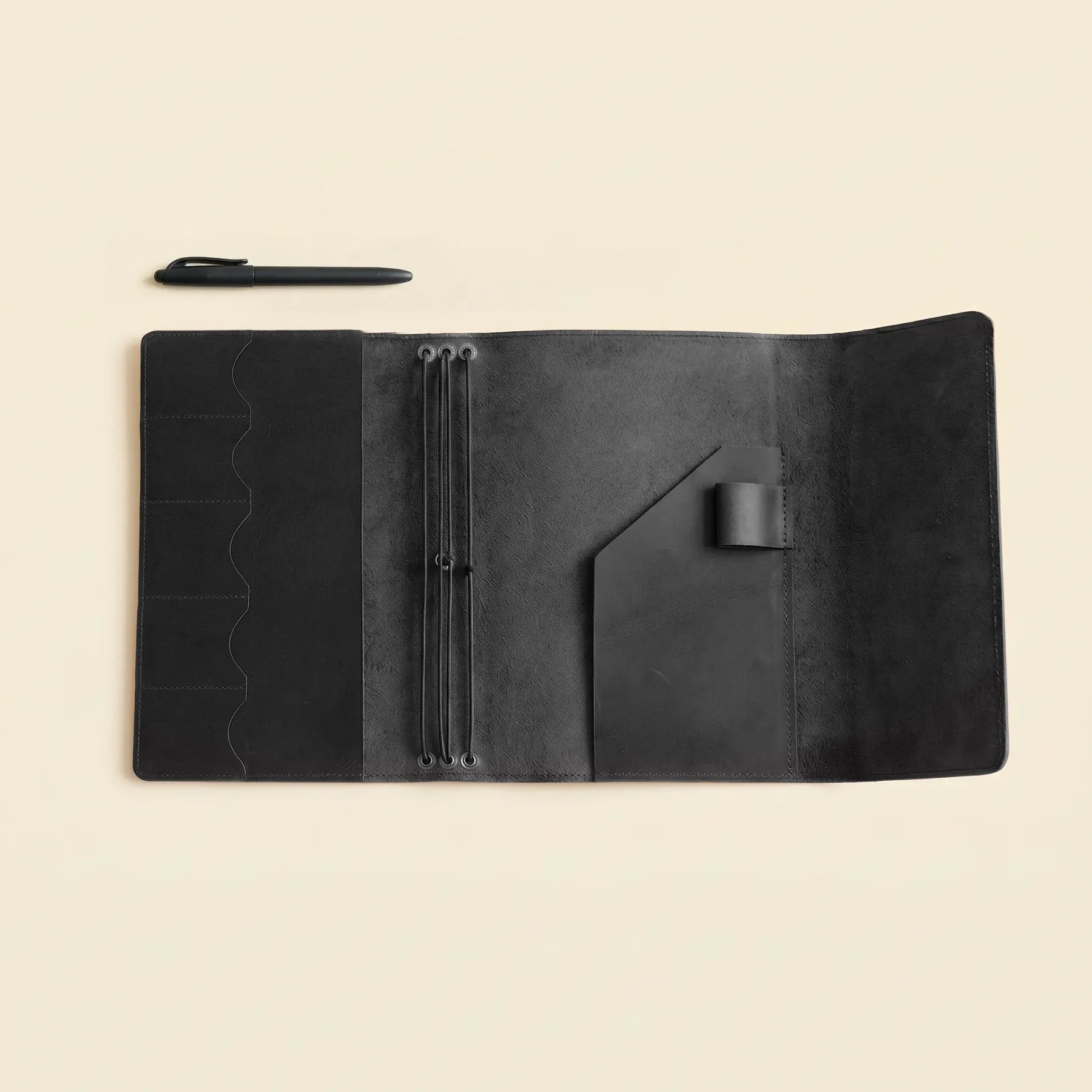 Leather notebook organizer featuring refillable inserts and pen holder loop.