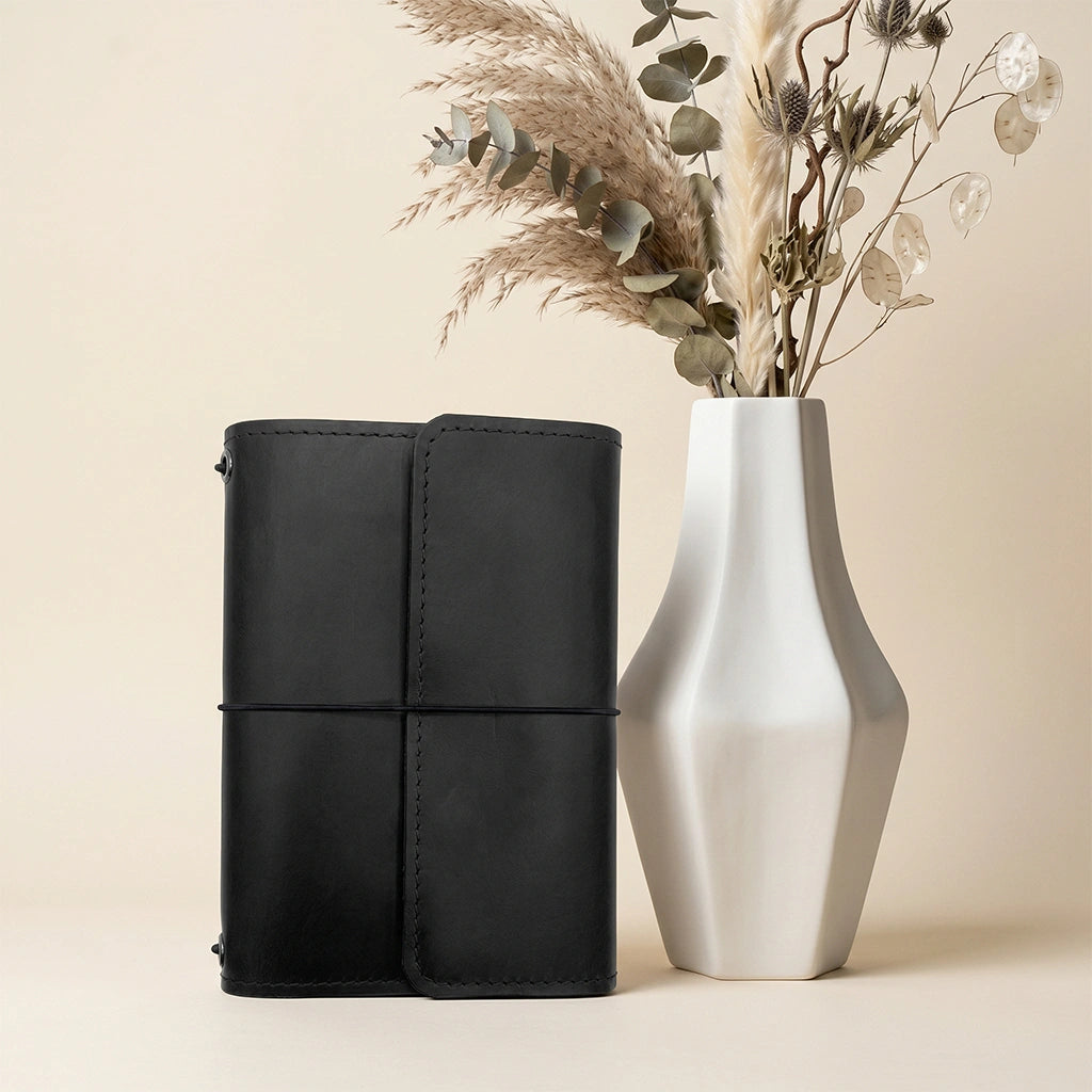 Premium leather notebook organizer with elastic straps, card slots, and pen loop.