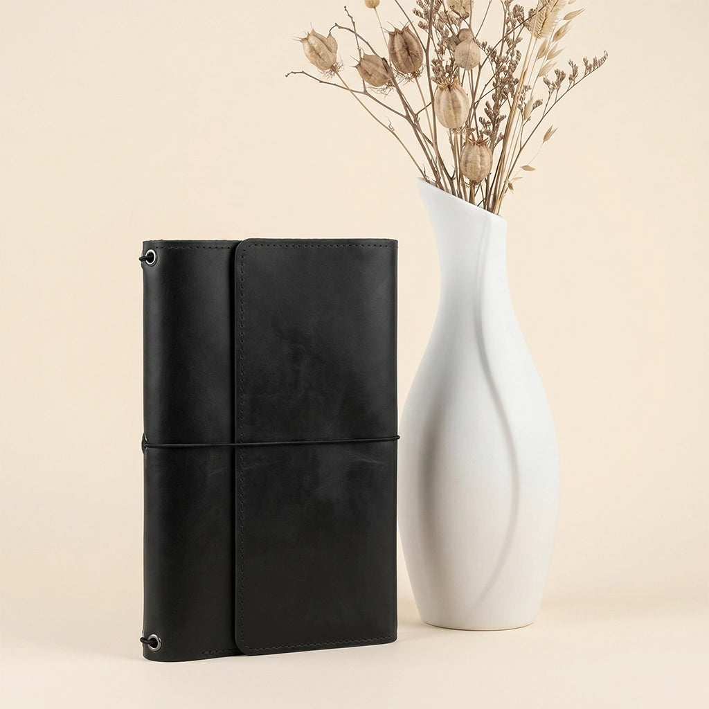 Stylish leather writing cover featuring elastic notebook bands and interior organization.