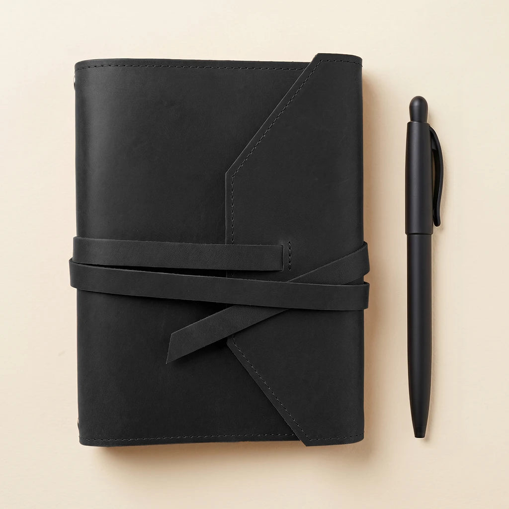 Sleek leather journal case with pen loop and flexible elastic bands.
