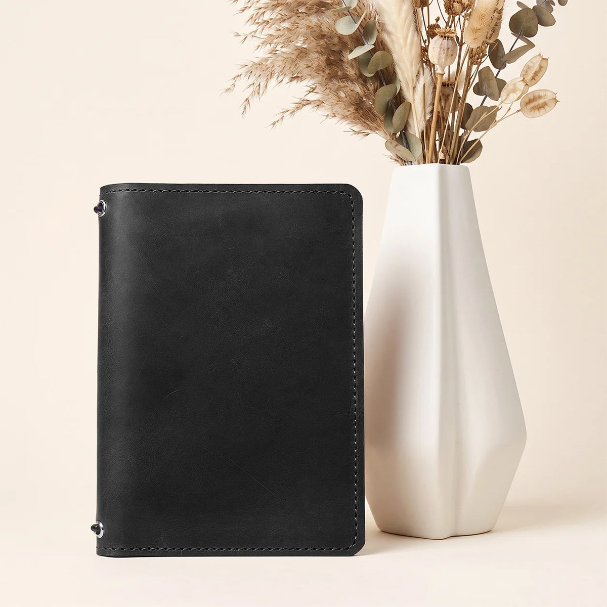 Natural leather planner holder with two elastic retainers and neatly structured internal storage