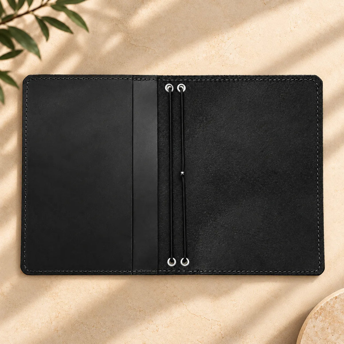 Natural leather journal holder with two elastic straps and functional interior pockets.