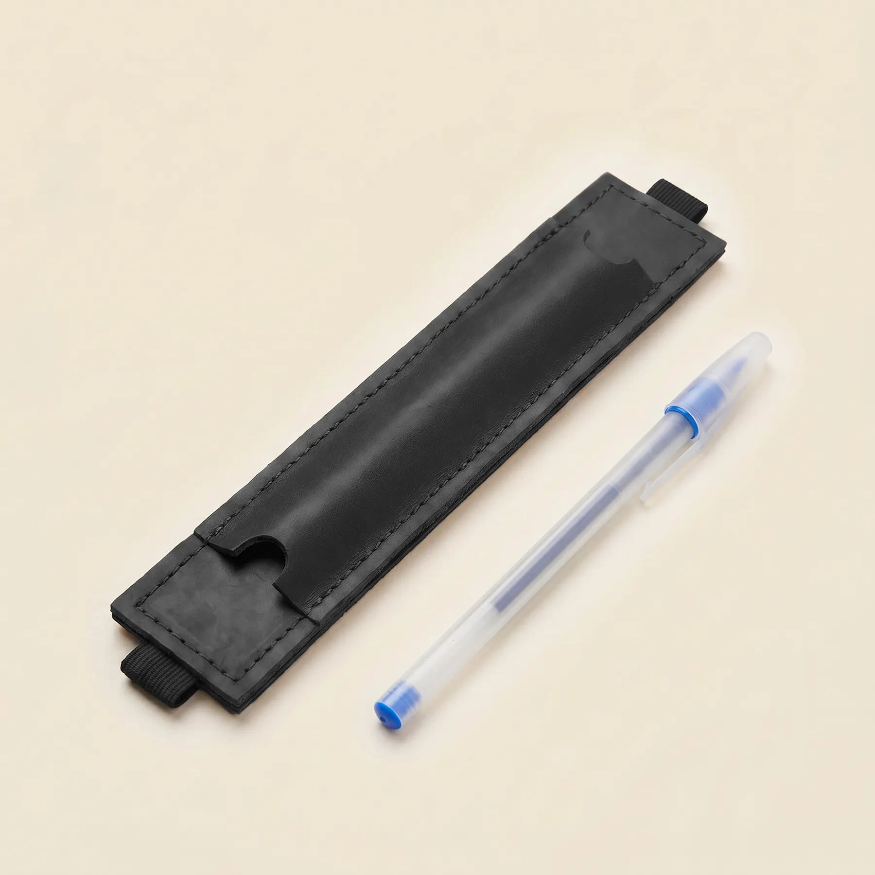 Functional leather notebook pen holder with flexible elastic band for daily organization.