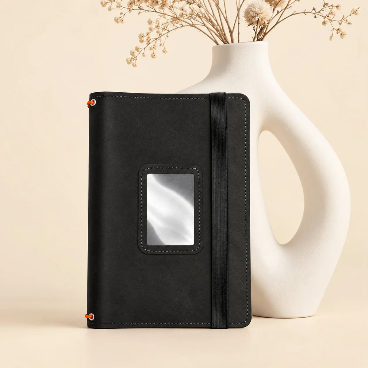 Leather notebook cover with three flexible elastic bands and organized interior storage pockets.