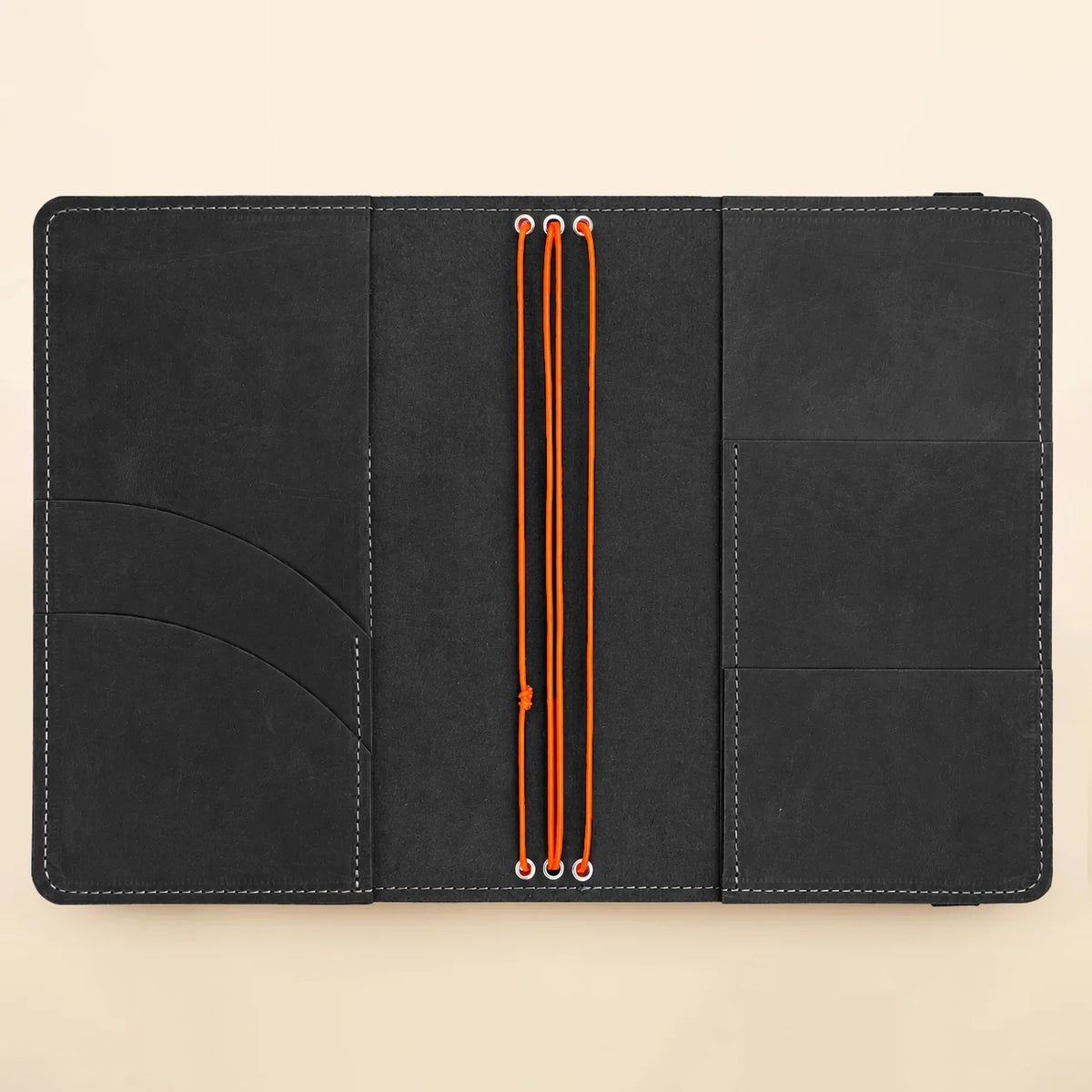 Genuine leather notebook case with three secure bands and organized compartments for stationery.