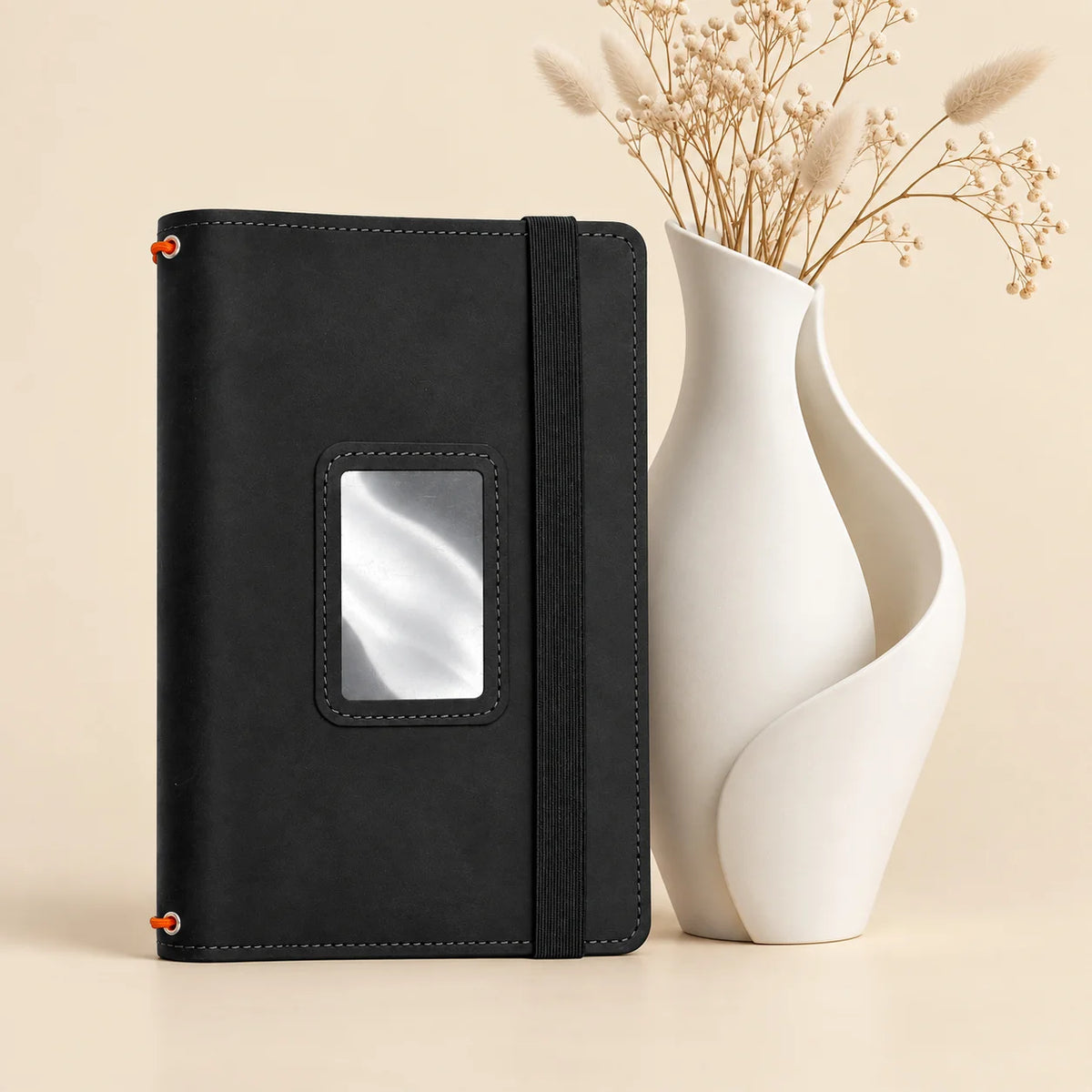 Leather journal cover with organized pockets inside and three elastic bands for inserts.