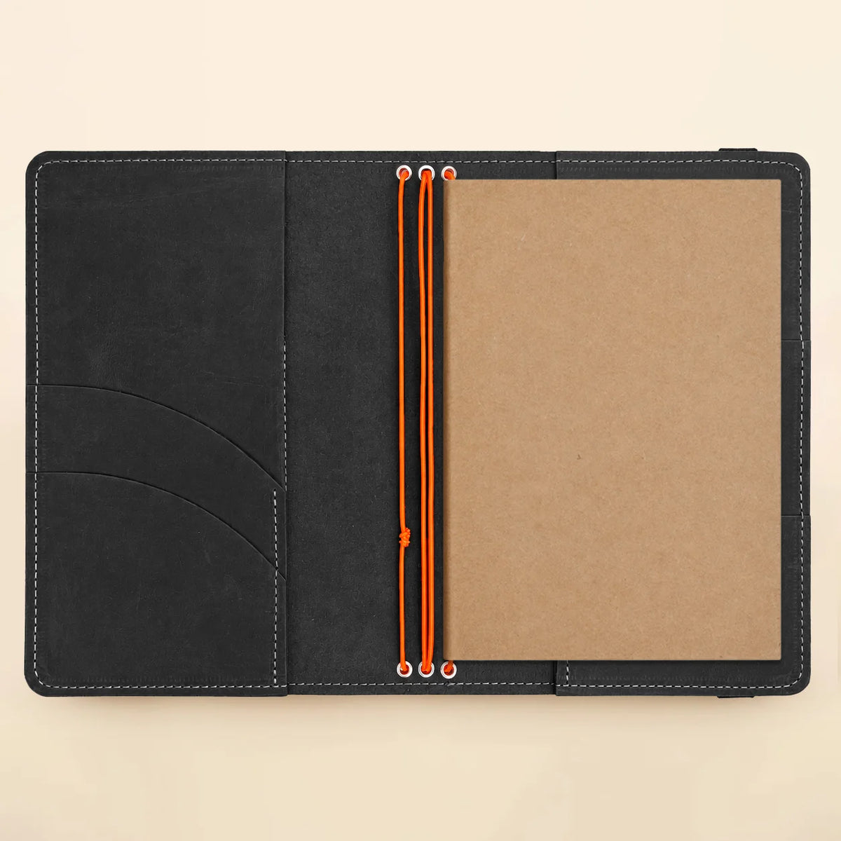 Genuine leather journal case showing three elastic holders and thoughtfully arranged interior pockets.