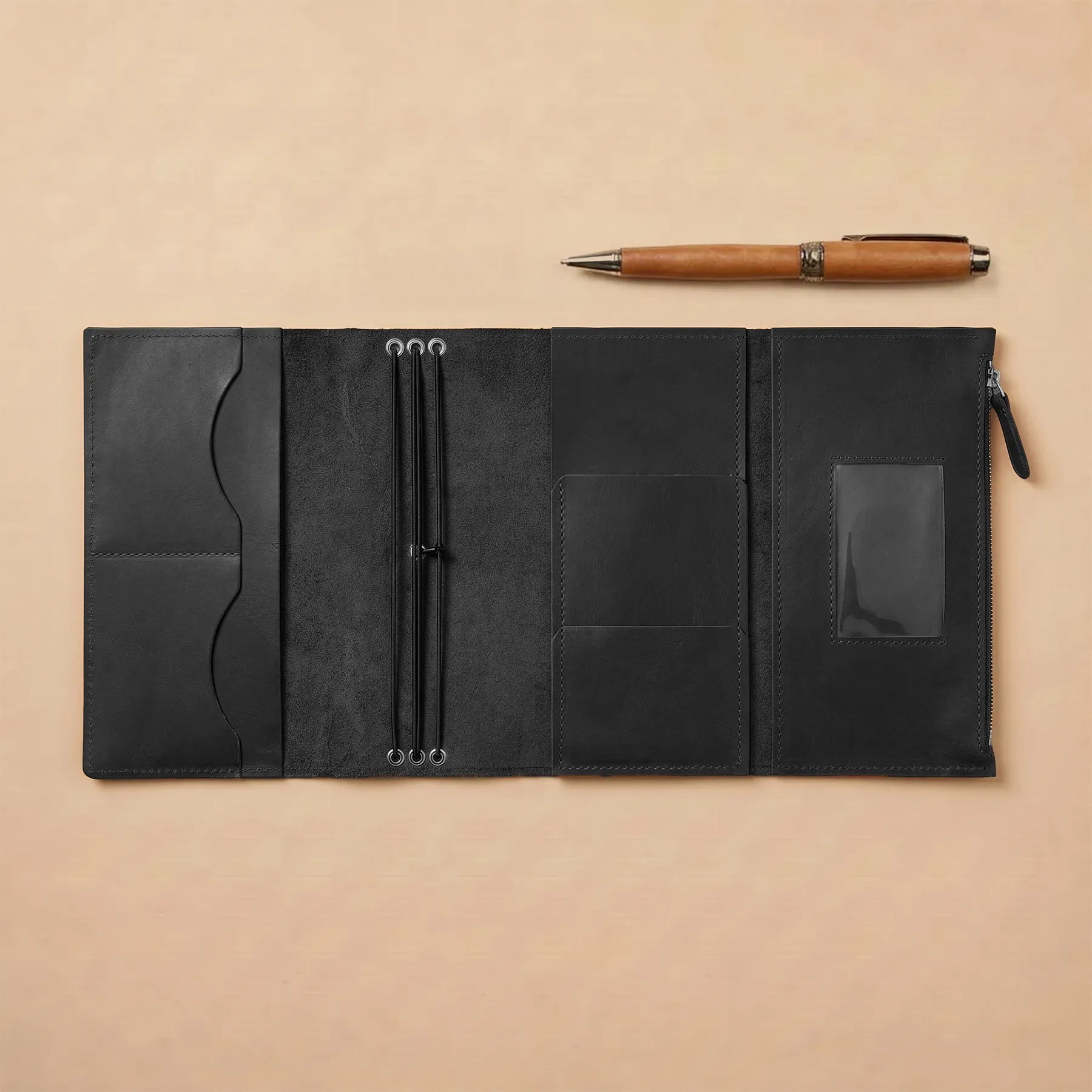 Handmade leather notebook organizer with refillable inserts and secure elastic closure.