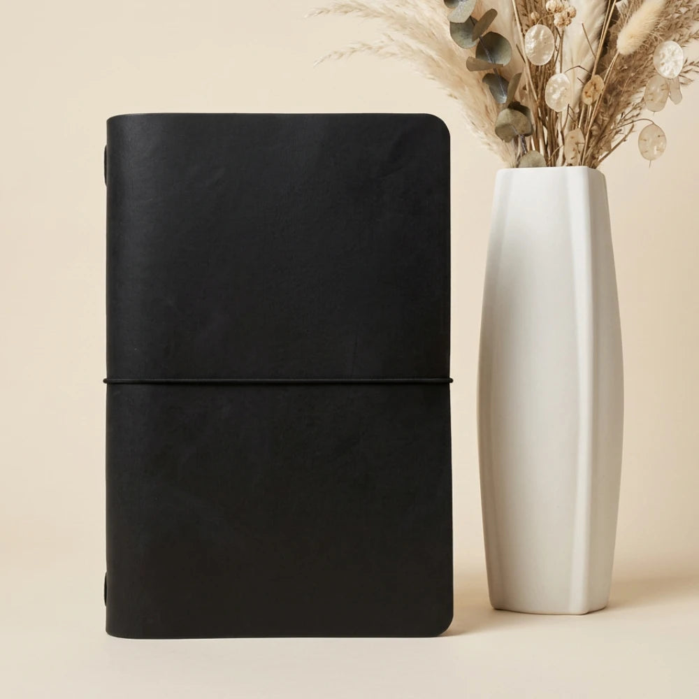 Handmade leather notebook organizer featuring natural texture and a simple interior layout.