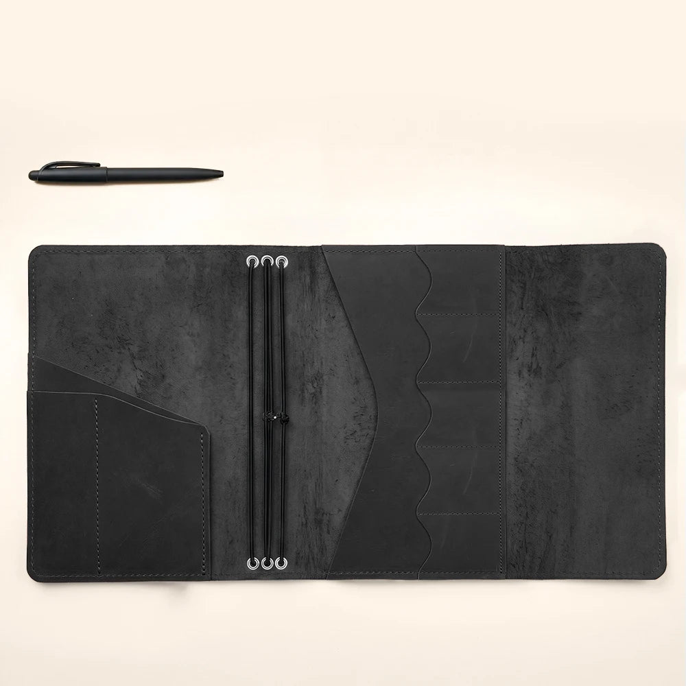 Leather planner organizer with premium construction and refillable notebook holding capability.