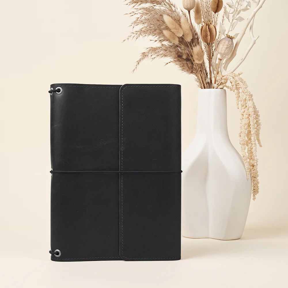 Handmade leather portfolio with refillable notebook design and spacious interior organizer compartments.