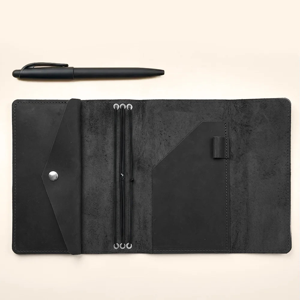 Leather travel journal organizer with three elastic bands and multiple practical inside compartments.