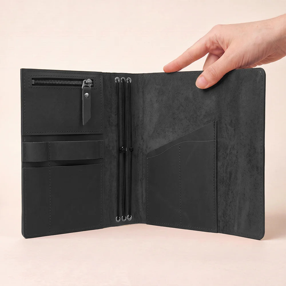 Premium leather notebook cover with spacious pockets and an integrated pen loop.