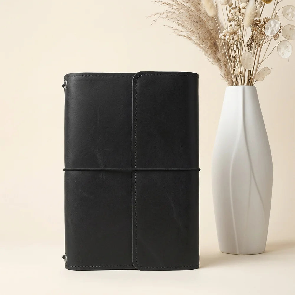 Handmade leather cover with multiple interior pockets and a secure built-in pen holder