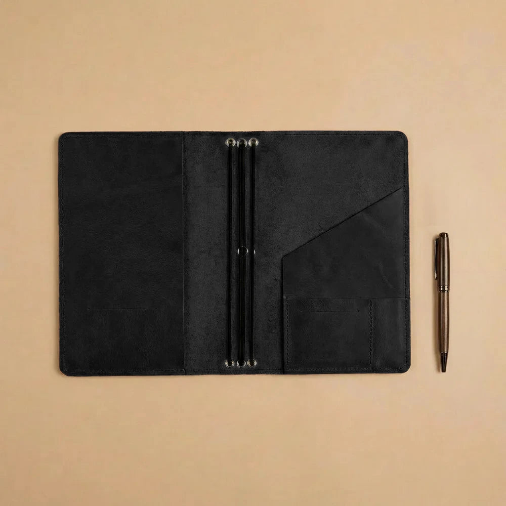 Leather notebook organizer crafted for refillable journals with practical storage and elastic bands.