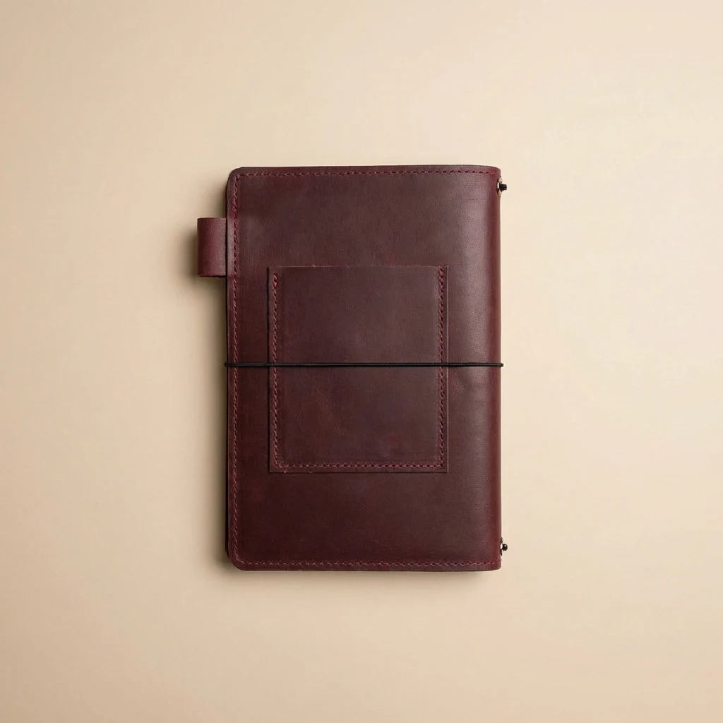 Brown leather notebook on a beige background