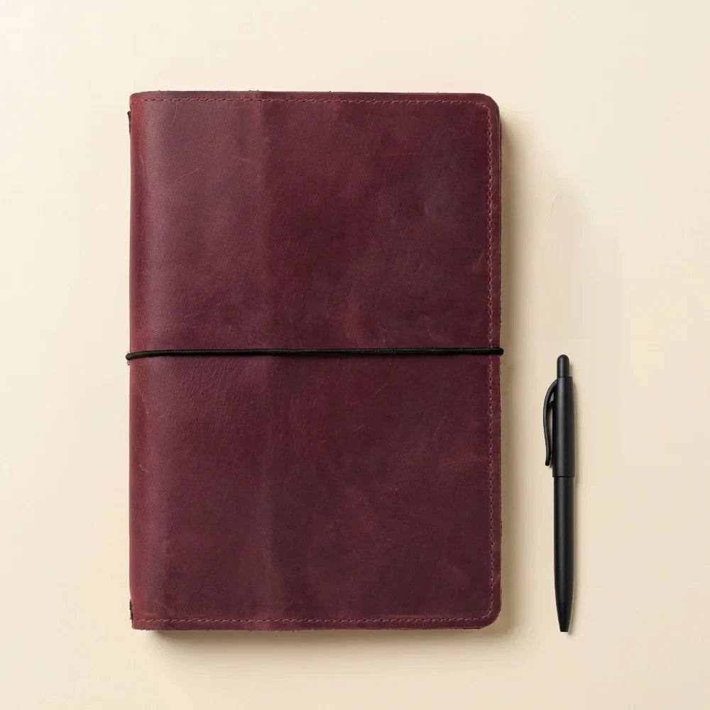 Refillable journal cover made from genuine leather with organizer pockets and elastic loops.