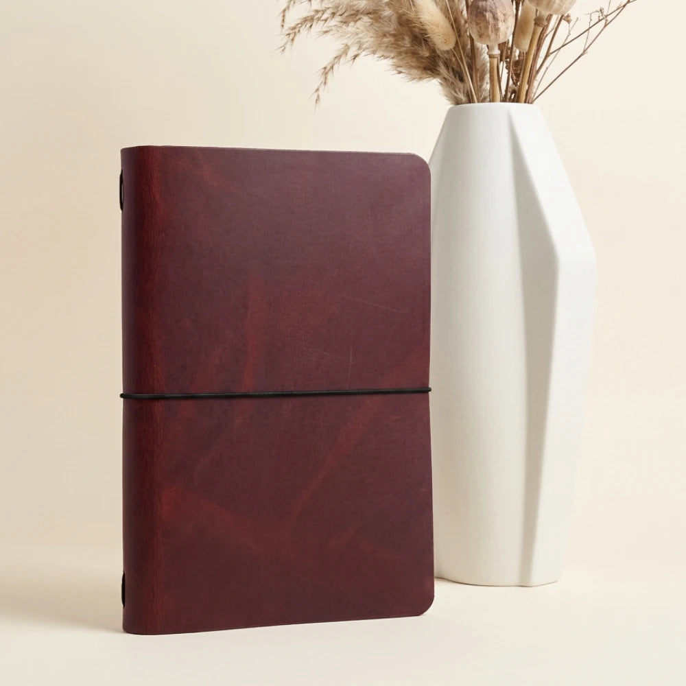 Handmade genuine leather sleeve designed to protect and hold a notebook securely.