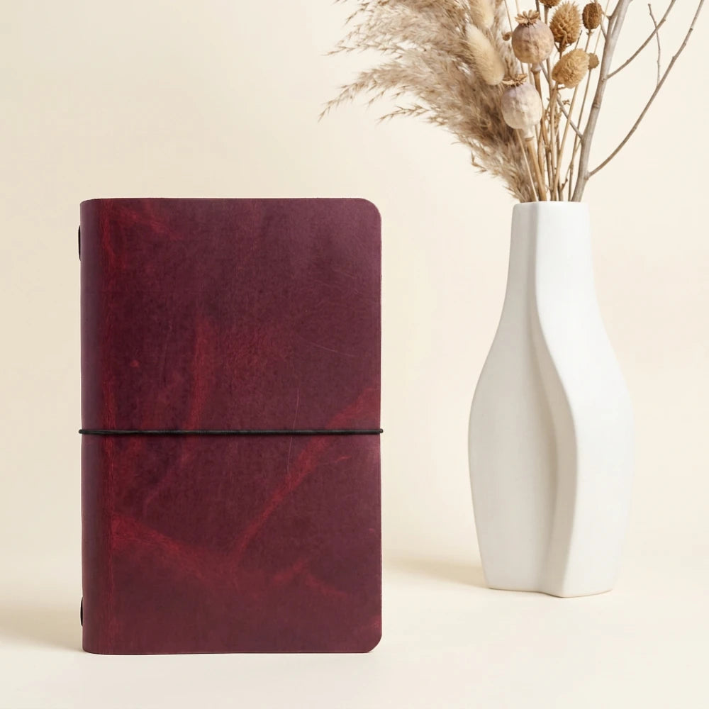 Natural leather journal cover designed to hold a simple notebook using one elastic.