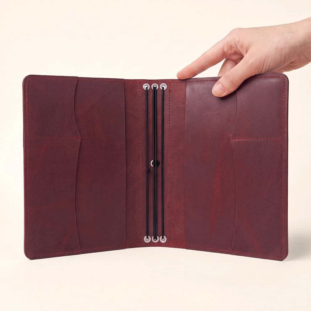 Premium leather notebook cover with convenient interior pockets and durable pen loop design.