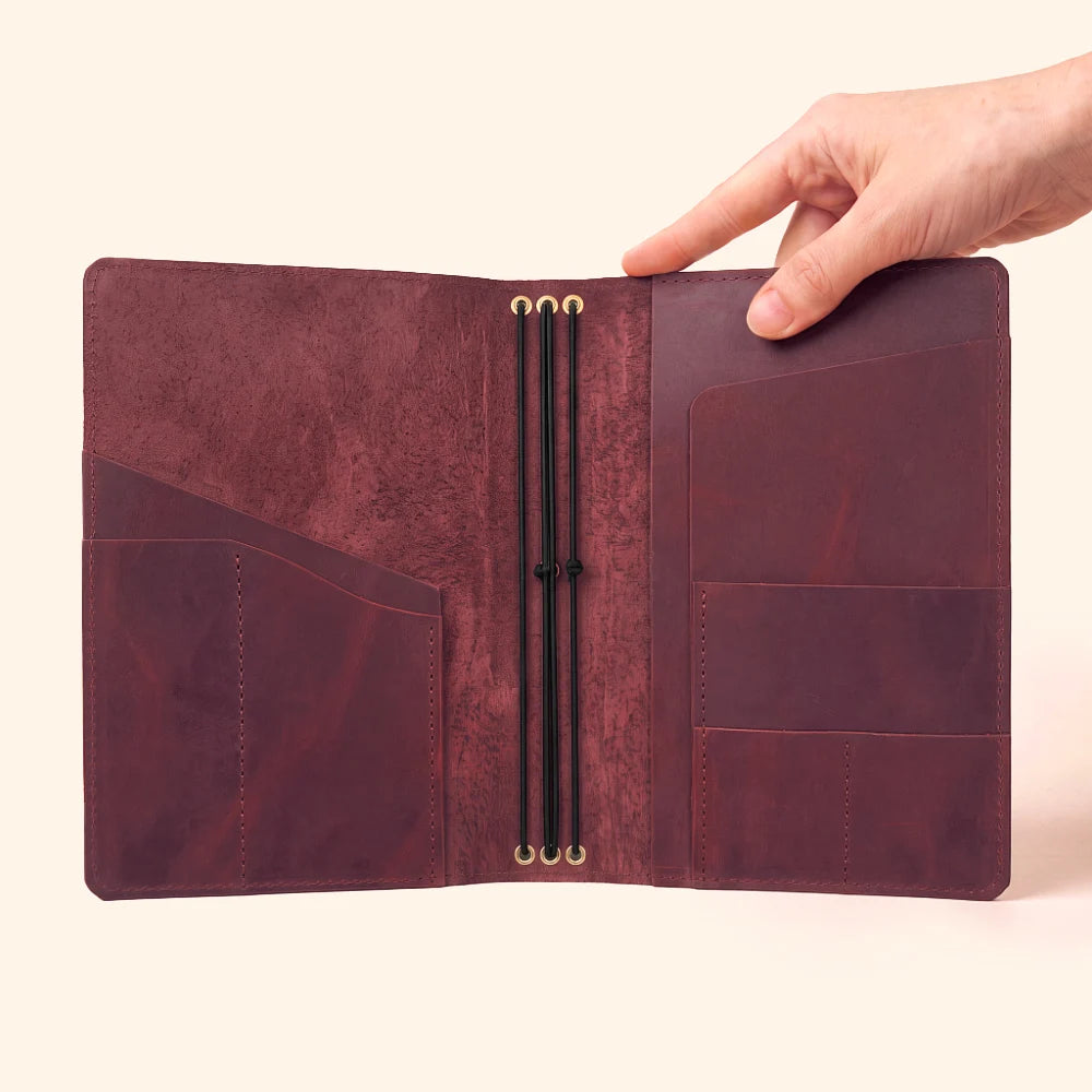 Genuine leather notebook cover with three elastic bands for customizable journal organization.