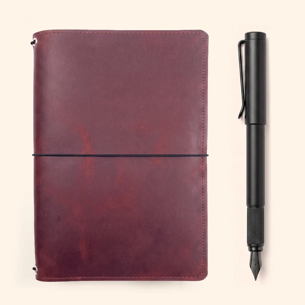 Handmade leather travel notebook cover featuring three interior elastic loops.