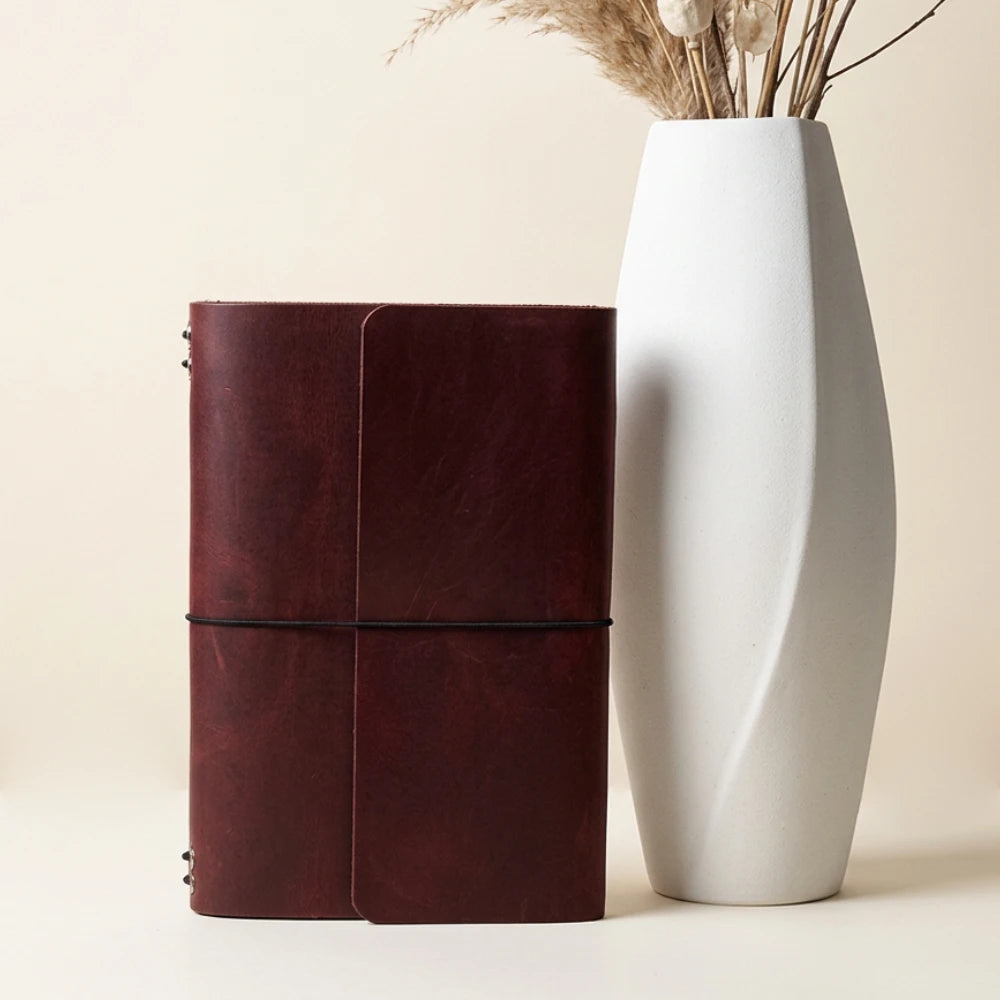 Genuine leather writing organizer with six stretch bands for customizable notebook storage.